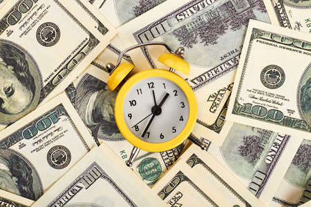Alarm clock and dollars. Time is money.の写真素材