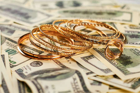 Golden jewelry and money. Expensive and unrighteous lifestyle.の写真素材