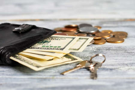 Keys and purse with money. Satisfaction with life.の写真素材