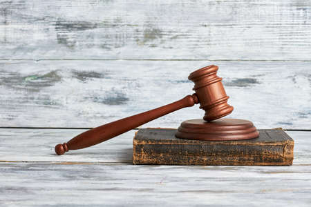 Law mallet on wooden surface. Justice will prevail.の写真素材