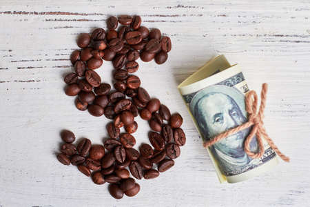 Roasted coffee beans and dollars. Create your business.の写真素材