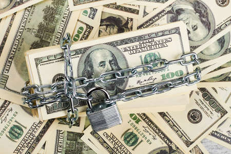 American dollars wrapped in chain. Financial security and stability.の写真素材