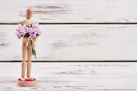 Manikin on wooden background. Invite her for a date.の写真素材