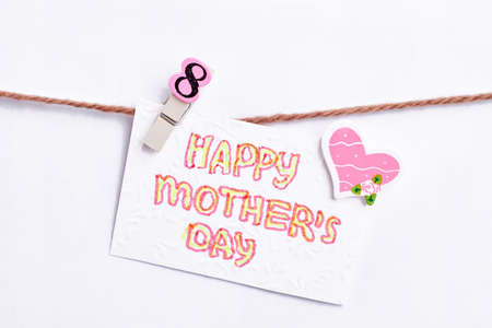 Greeting card on clothesline. Heartful surprise for mother.
