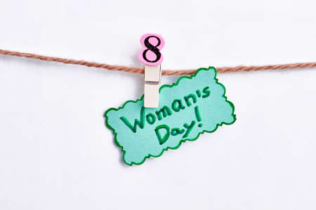 Card and clothes pin. International Womens holiday.