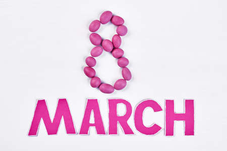 Dragee on white surface. Laconic congratulation for women.の写真素材