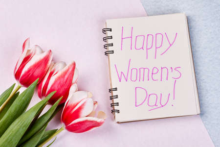 Notebook and flowers. Creative congratulation with Womens day.