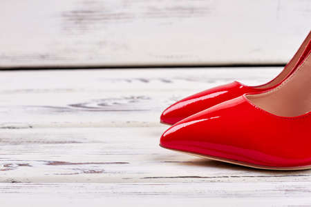 Shoes on wooden background. Elegant present for lady.の写真素材