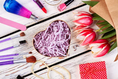 Tulips, cosmetics and heart-shaped box. Attention to woman.の写真素材