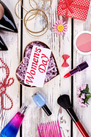 Heart-shaped box, cosmetics and card. International Womens day.