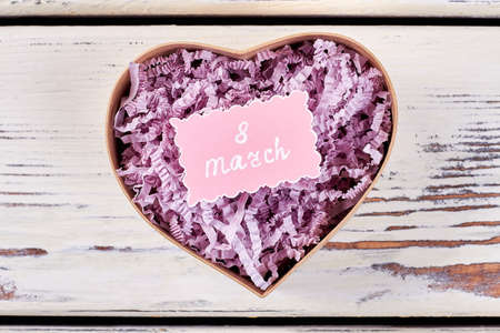 Present box on wood. Congratulation with 8th March.の写真素材