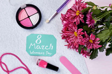 Greeting card, flowers and cosmetics. Gifts for international Womens Day.