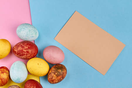 Easter eggs with blank card. Dyed eggs on paper background.の写真素材