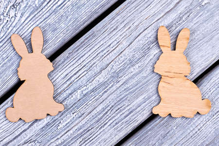 Plywood Easter rabbits. Cutout figurines of bunnies. Animalistic decorative items.の写真素材