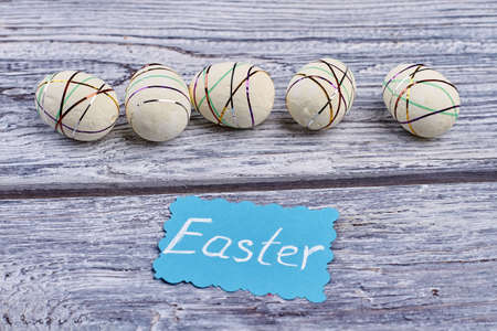 Easter card and polystyrene eggs. White styrofoam eggs on wood. Creative Easter ideas.