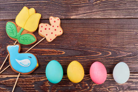 Colored eggs and cookies. Easter background with copyspace. Healthy and tasty Easter food.の写真素材