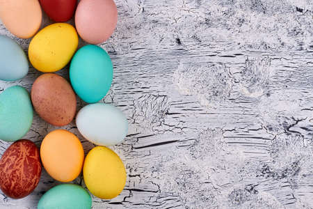 Easter eggs, painted wood texture. Bright chicken eggs and copyspace.の写真素材