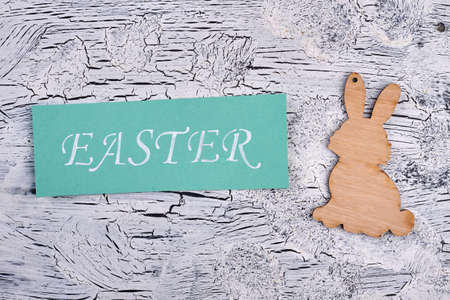 Easter card, plywood rabbit cutout. White painted wood texture. Cheap Easter souvenirs.の写真素材