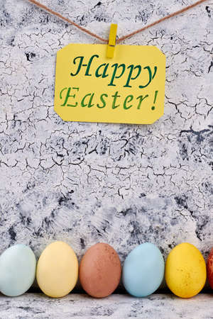 Row of painted Easter eggs. Greeting card, rope and clothespin.の写真素材