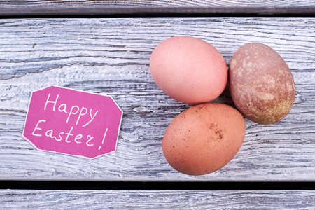 Some eggs on wooden background. Greeting card for Easter. Wishing happy Easter composition.