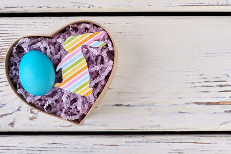 Easter egg, heart shaped box. Colorful paper rabbit cutout. Fresh ideas for cute presents.の写真素材
