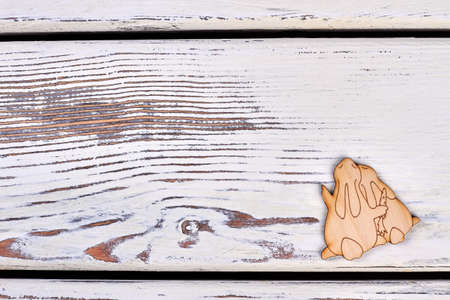 Rabbits plywood cutout. Wooden surface with copyspace. Small Easter souvenir.の写真素材
