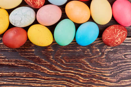 Brown wood background, Easter eggs. Colorful chicken eggs.の写真素材