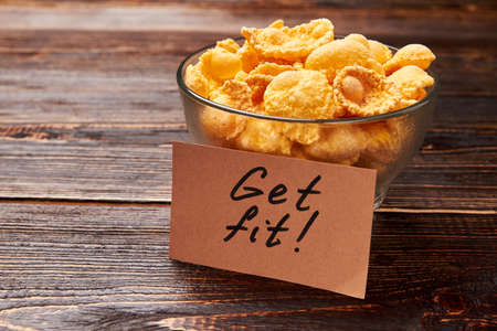 Cornflakes on wooden background. Healthy breakfast ideas.
