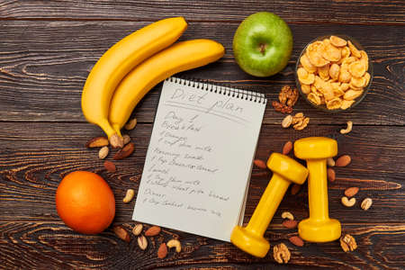 Apple, orange and dumbbells. Main keys to health.の写真素材