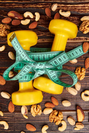 Dumbbells and variety of nuts. Start living your best life.の写真素材