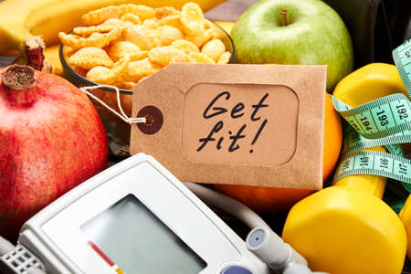 Tonometer, label, dumbbells and fruits. Key to a healthy life.の写真素材