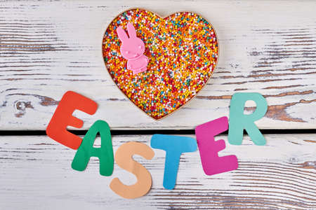 Easter paper lettering on wood. Heart box, bright sprinkle dots.