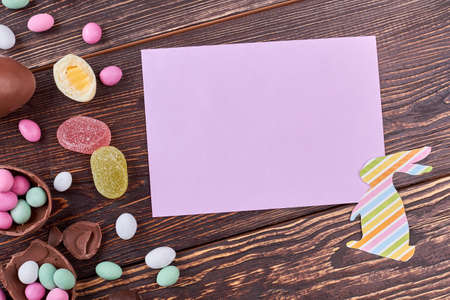 Sweets and empty card. Bright bunny cutout.