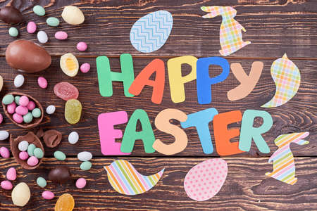Candies and Easter paper decorations. Bright colored cutouts. Art and craft handmade.