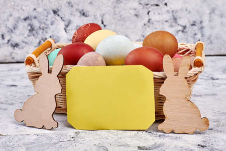 Easter basket, blank yellow card. Plywood rabbit cutouts. Easter party invitation.