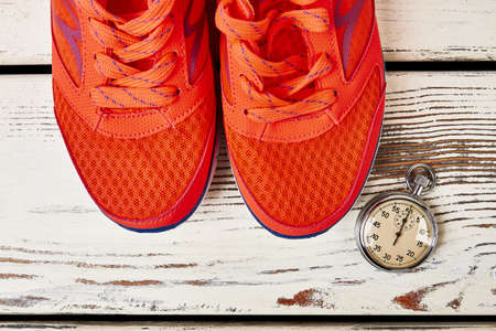 Sport shoes and stopwatch. How to lose weight walking.の写真素材