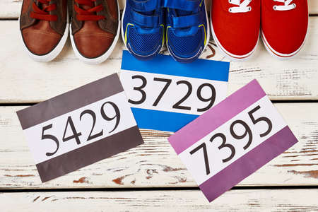 Sneakers and numbers on wood. Steps towards sport achievements.の写真素材