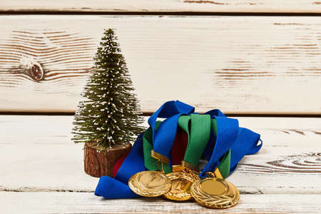 Medals and fir-tree on wood. Set your goals high.の写真素材