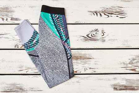 Sports trousers on wood. Formula of healthy life.の写真素材