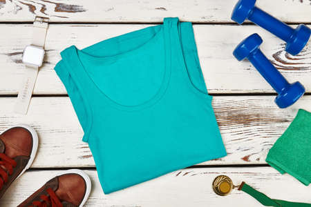 Dumbbells, tank top and medal. How to become successful.の写真素材