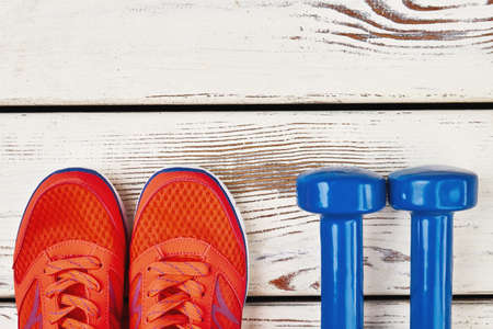 Women's sneakers and dumbbells. Time to get healthier.の写真素材