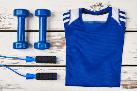 T-shirt and dumbbells. Setting goals is first step.の写真素材