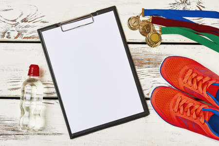 Clipboard, water and gumshoes. Outdoor sport competition.の写真素材