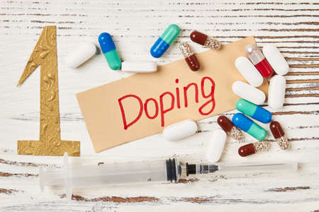 Syringe, pills and card. Risks of dopping insport.の写真素材