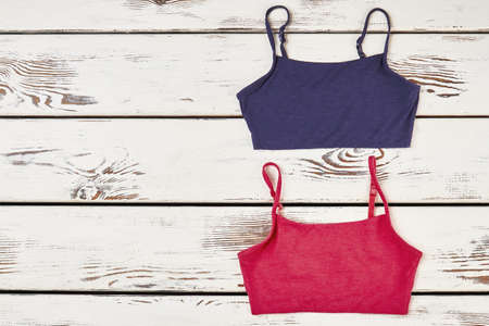 Female shirts on wooden surface. Simple and attractive.の写真素材