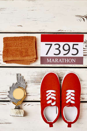 Towel, sport shoes and award. Greatest sporting achievement.の写真素材