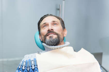 Person in a dental chair. Man at the dentist.