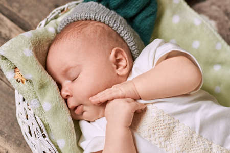 Adorable sleeping baby. Infant lying on towel.の写真素材