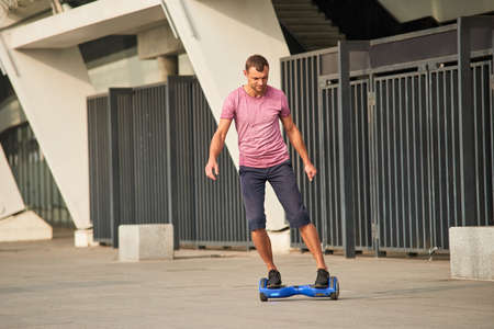 Man riding hoverboard. Young male in the street.の写真素材