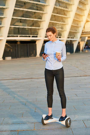 Businesswoman on a hoverboard. Female with cup and phone. Time management tips.